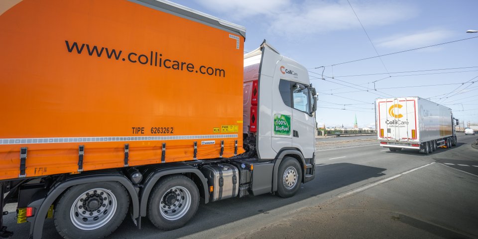 Two ColliCare trucks driving on a highway, en route to their destination.